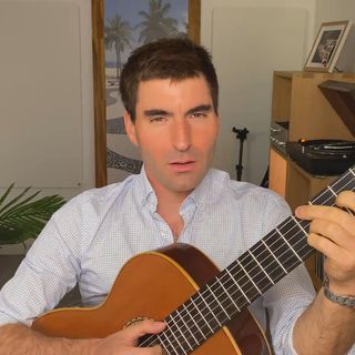 A thumbnail from the music video featuring me playing the guitar and singing. Une vignette du clip vidéo dans laquelle je joue de la guitare et chante.